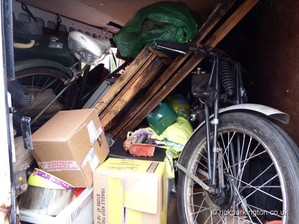 van brimful of boxes, a bicycle, the Martinsyde and a dismantled shed